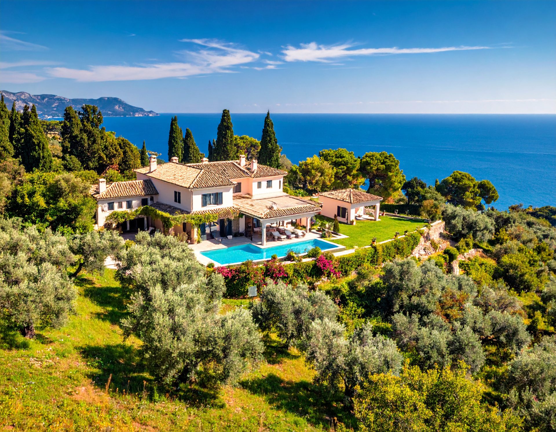 A panoramic view of a stunning Corfu coastline or a luxury villa with a clear blue